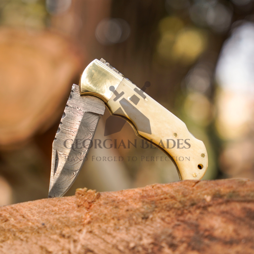 Skeletal Saber - Custom Hand Forged Damascus Folding Knife Engraved Brass Bolster With Bone Handle