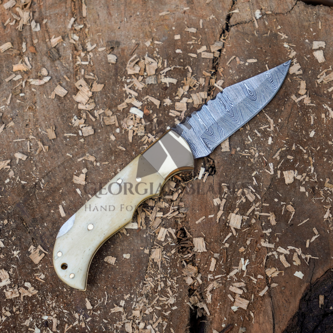 Skeletal Saber - Custom Hand Forged Damascus Folding Knife Engraved Brass Bolster With Bone Handle