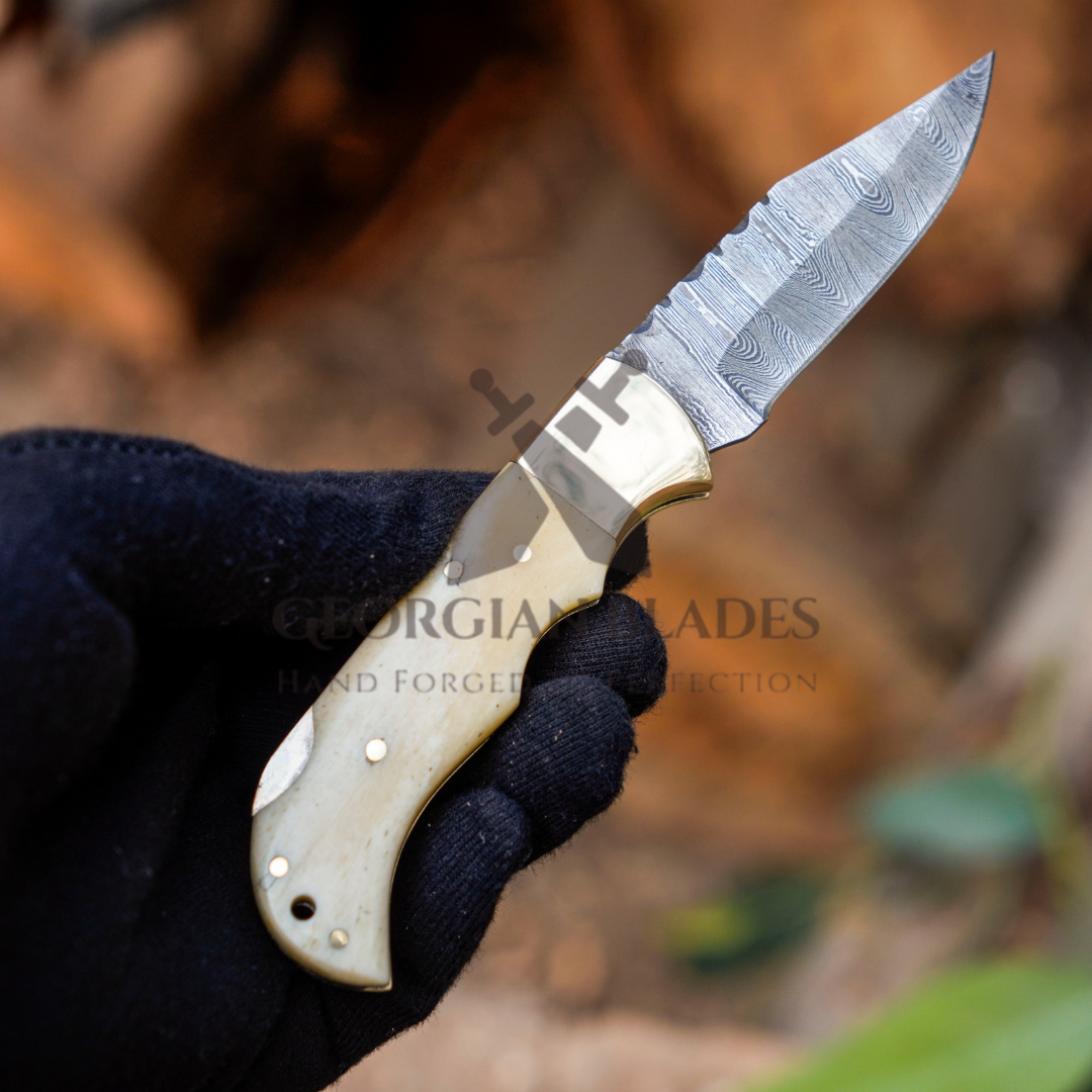 Skeletal Saber - Custom Hand Forged Damascus Folding Knife Engraved Brass Bolster With Bone Handle