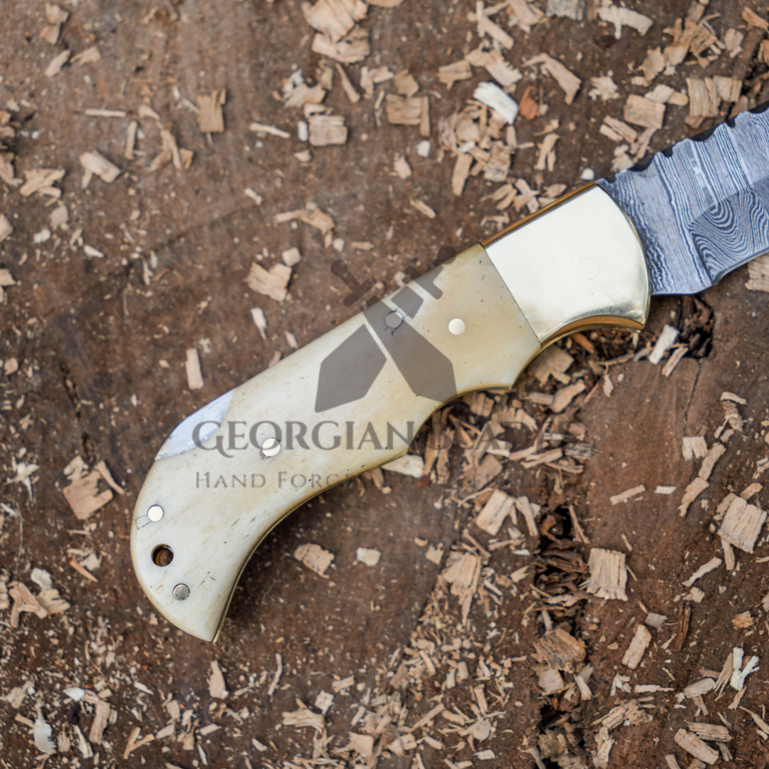 Skeletal Saber - Custom Hand Forged Damascus Folding Knife Engraved Brass Bolster With Bone Handle